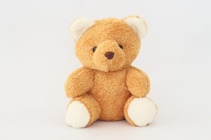 Teddy Bear looks cute on a white background.