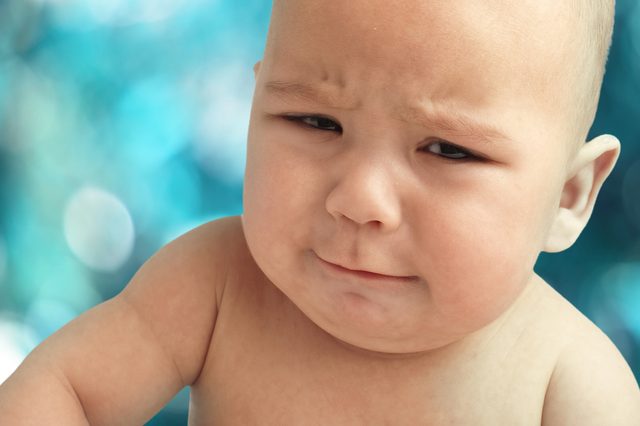 strange baby face on a lights background