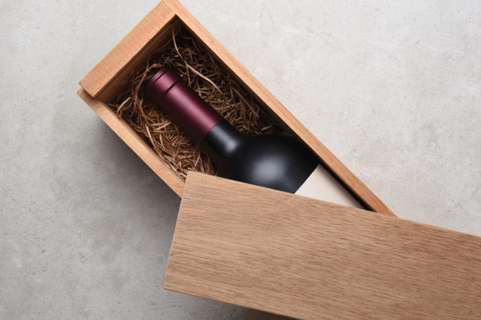 Cabernet Wine Box: A single bottle of red wine in a wood box partially covered by its lid.