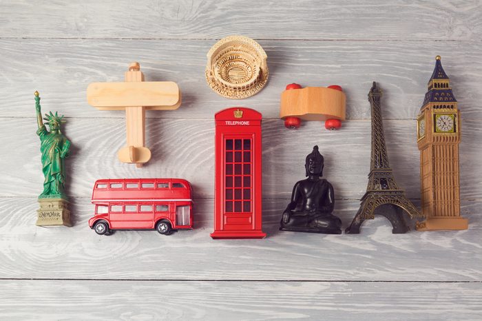Travel and tourism background with souvenirs from around the world. View from above. Flat lay