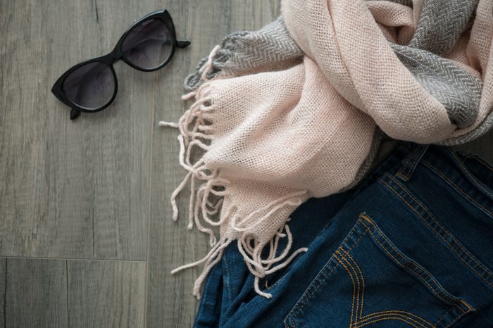 Flat lay of winter cloth and accessory on wooden table with copy space