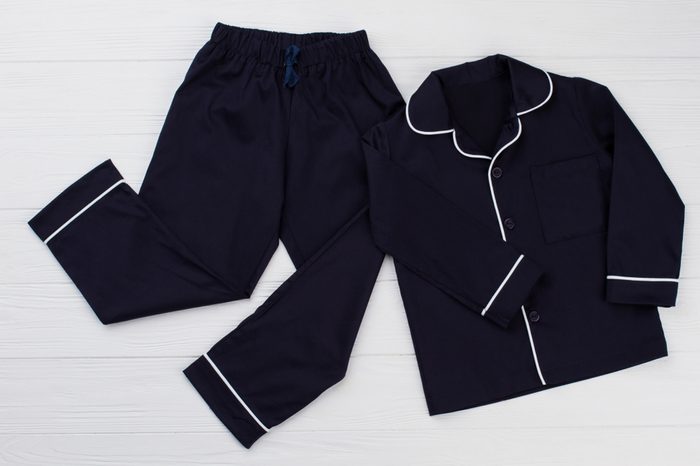 Classic pajama for young boy. Navy shirt and pants decorated with white edging. Simple and elegant.