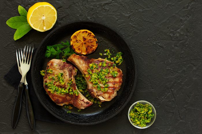 Pork cutlet on a bone with gremolat sauce.