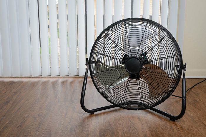 black metal ventilation fan on wooden floor