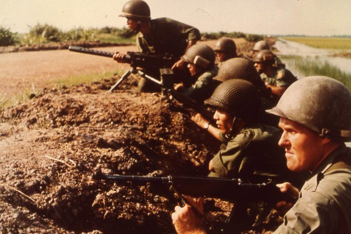 U.s. Army Advisors And Vietnamese Infantrymen Await Attack Along Bank Of A Rice Paddy