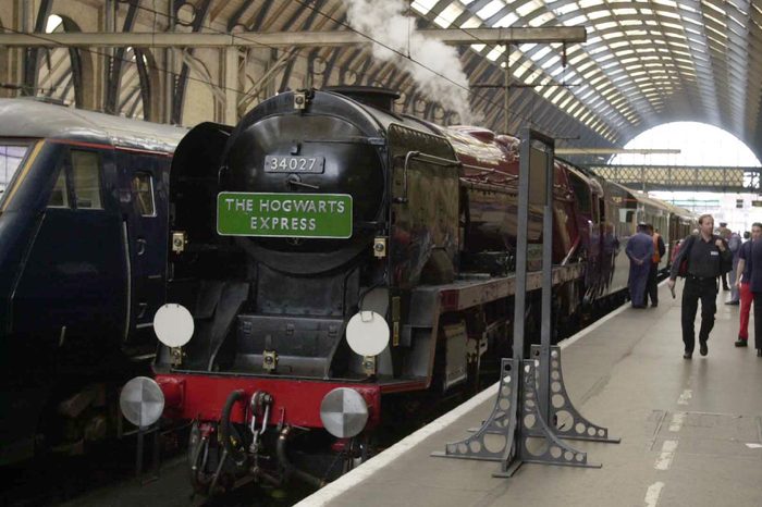 J.k (joanne) Rowling And The Hogwarts Express At Kings Cross Station For The Launch Of The New Harry Potter Book - J.k. Rowling And Her Minders Arrive For The Hogwart Express At King's Cross Station For The Launch Of The New Harry Potter Book - The Creator Of Publishing Phenomenon Harry Potter Is Being Protected 24 Hours A Day From A Male Stalker Who Has Showered Her With Love Letters And Been Seen Standing Outside Her Home - Two Female Bodyguards Have Been Assigned To Jk Rowling While She Promotes Her Fourth Harry Potter Book Which Began Shattering Publishing Records From The Moment It Was Released At Midnight On Friday - The Fan Understood To Be A Scottish Teacher In His 30s Has Not Made Any Specific Threats To The Millionaire Author - But His Obsessive Behaviour Has Alarmed Her Advisers And Private Security Personnel Will Accompany The 34 Year Old Writer On Her Four-day Round Britain Tour In A Steam Train - Ms Rowling Look Tired And Anxious As She Set Off From Londonn On The Hogwarts Express - Named After The Special Train Which Takes Trainee Wizard Harry On His Adventures And Which As In The Books Departed From Platform 9 At Kings Cross - It Should Have Been A Triumphal Departure - The First British And Us Print Run Of 5.3 Million Copies Of Harry Potter And The Goblet Of Fire Has Amazon Internet Bookselling Site Totted Up 370 000 Sales - More Than Six Times The Record Set In March By John Grisham's The Brethren - Ms Rowling A Single Mother With An Eight Year Old Daughter Who Was Penniless Three Years Ago Can Expect To Earn A60 Million From The New Book On Top Of Royalties From The 30 Million Sales Of The First Three Which Have Been Translated Into 31 Languages.