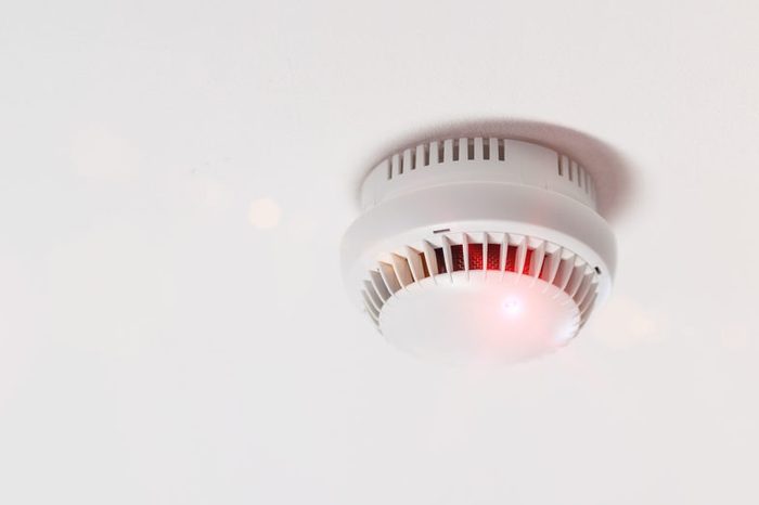 Smoke detector mounted on roof in apartment