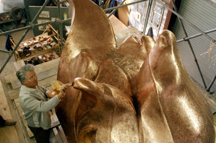 Robert Gohard, a member of the French team that is working on the restoration of the Statue of Liberty, puts finishing touches of gilding on the statue's new torch, 1985, in the same place where the original torch was constructed