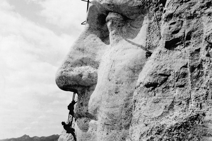 Mt. Rushmore, South Dakota: c. 1932. Workmen working on the face of George Washington on Mt. Rushmore.