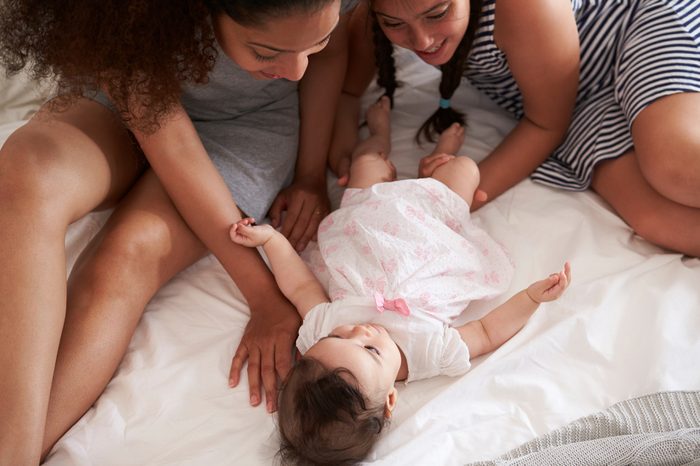 Mother And Daughter Playing With Baby At Home At Home