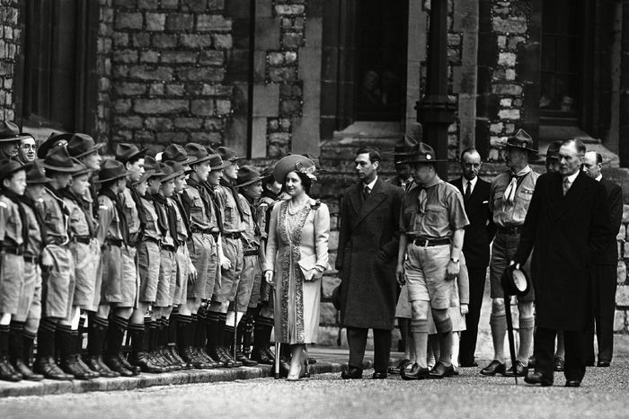 Britain's King George VI and Queen Elizabeth inspects the ranks of Scouts at the National Boy Scout rally in the grounds of Windsor Castle, on St. George's Day, . The royal family reviewed the Scouts before the dedication service to scout ideals in the chapel of St. George, attached to the castle. Scout troops and old Scouts attended the rally. This year great weight was given to the dedication service by the movement, at a time when, they feel, the Scout spirit is most wanted in the world