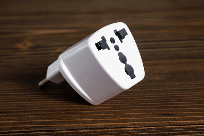 Universal plugs adapters on wood background