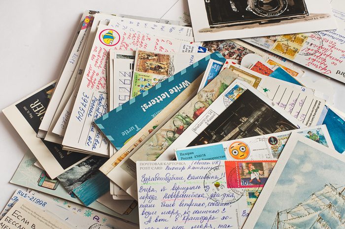 Pile of written postcards in disorder. Postcrossing footage. Postal mail. 2018