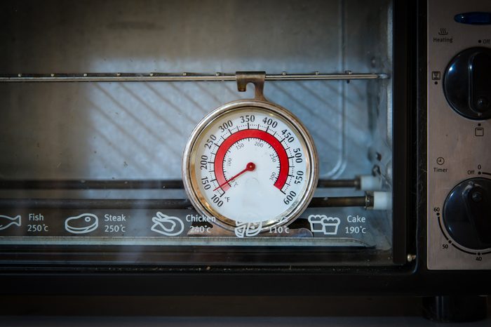 Old oven thermometer in the kitchen at home