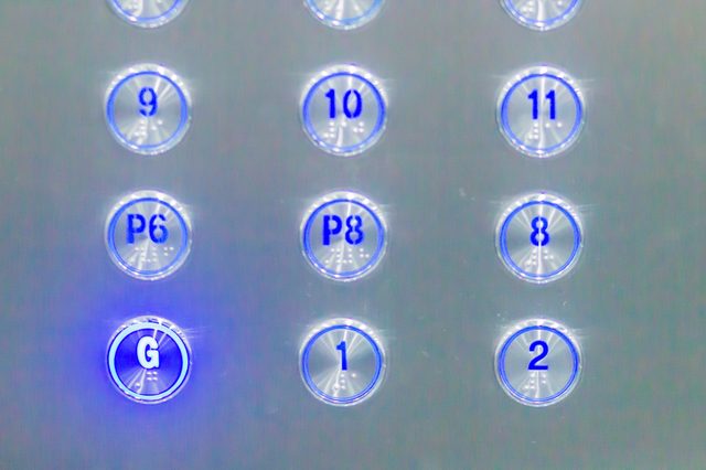 Elevator panel with illuminated buttons: G, P6, and P8 highlighted among 1, 2, 8, 9, 10, and 11, set against a metallic background.