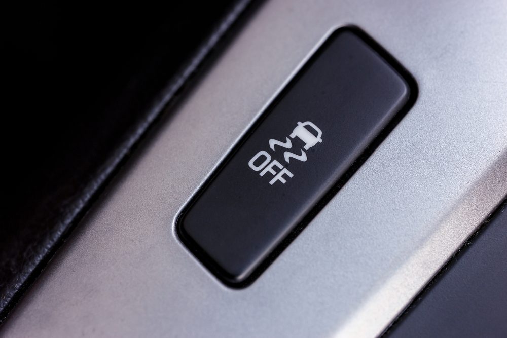 Button showing a skidding car symbol and "OFF," set within a metallic surface of a vehicle interior.