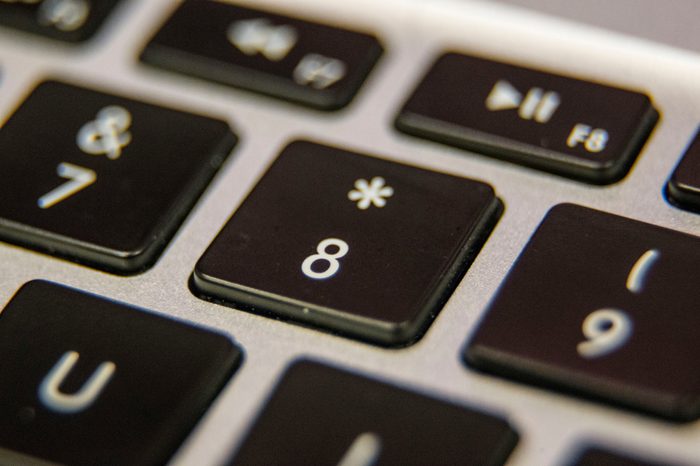 Eight 8 asterisk number keyboard key button press type close up macro desktop laptop computer black silver detail technology blog write letter alphabet