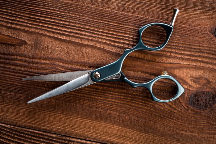 Scissors for cutting hair. For the barber. professional scissors for haircuts on the wooden background.
