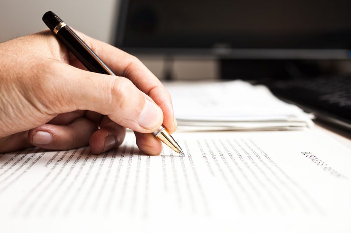 Closeup of a person writing on a document