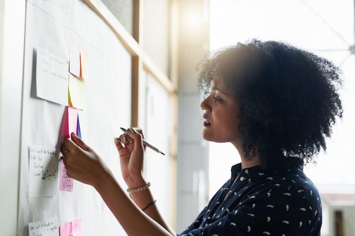 Shot of a young female designer working in her office