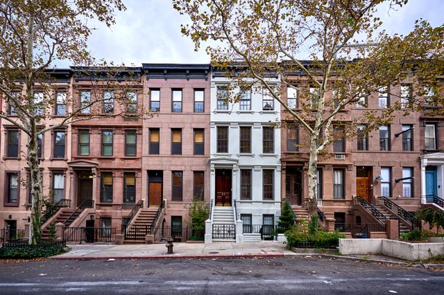 a view of a row of historic brownstones in an iconic neighborhood of Manhattan, New York City
