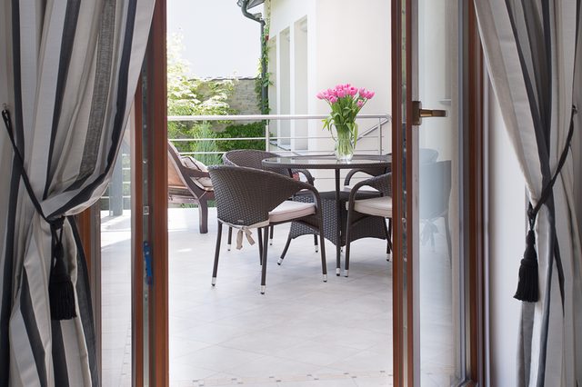 Close-up of open door to cozy terrace