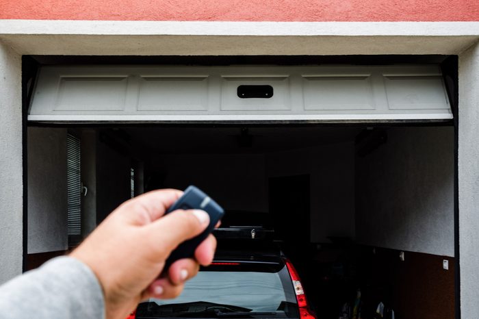 Garage door PVC. Hand use remote controller for closing and opening garage door.