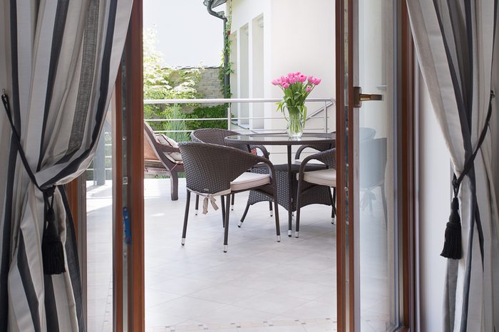 Close-up of open door to cozy terrace