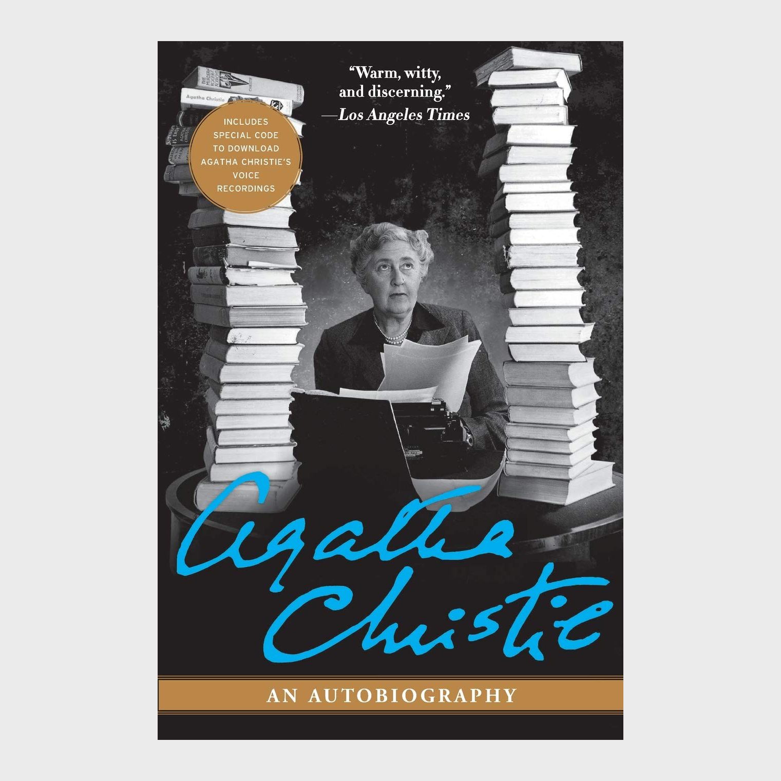 Woman sits typing amidst towering book stacks; "Agatha Christie: An Autobiography" title below; review excerpt and download code notice visible.