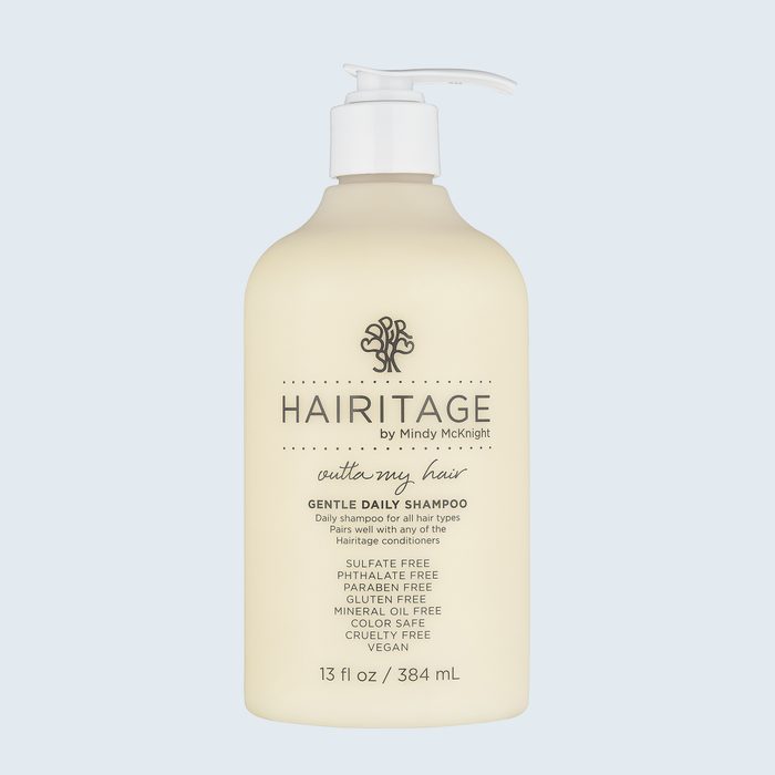 A shampoo bottle displays branding and product details against a light blue background. Contains text: 