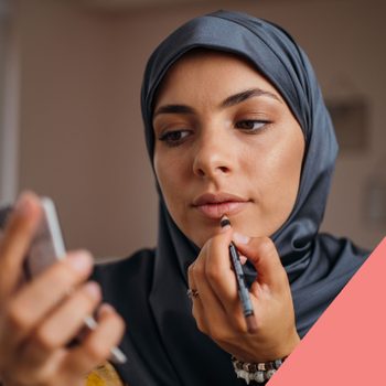 Woman applies lip liner, holding a mirror, seated indoors. Sephora lip liner product displayed with text: "SEPHORA, Colorful lips, rouge gel lip liner."