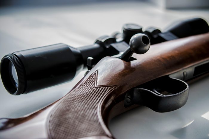 Long sniper rifle on table