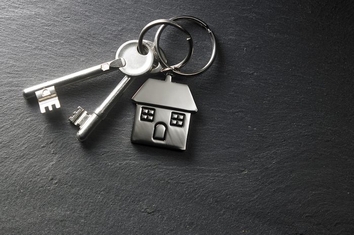 house shaped key chain on the black slate