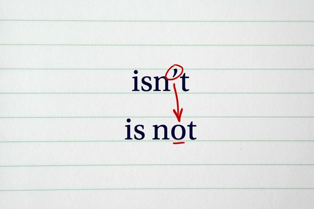 The image shows the word "isn't" transforming into "is not" using a red arrow on lined paper.