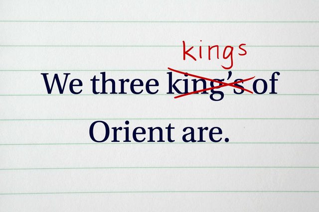 Text on lined paper with editing marks: "We three kings of Orient are." "king's" is crossed out, corrected to "kings."