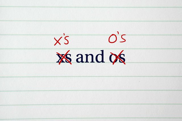 Text "xs and os" crossed out with red marks, replaced by "x's" and "o's" above, on lined paper background.