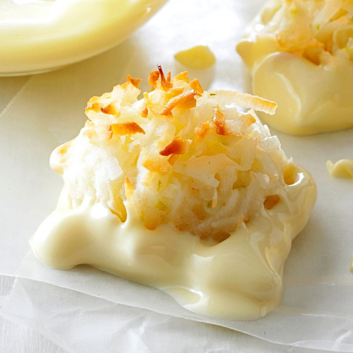 A coconut macaroon nestles atop melted white chocolate, set on parchment paper.