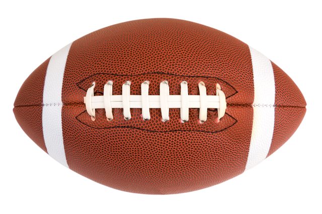 A brown leather American football with white laces and stripes rests against a plain white background.
