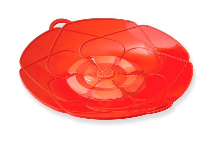 A red flower-shaped silicone lid with the word 