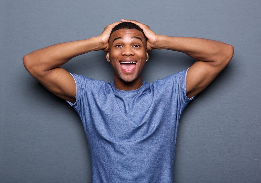 Portrait of a young man with surprised expression on face