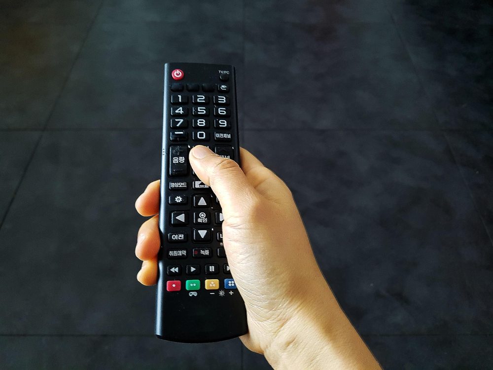 Woman hand remote control