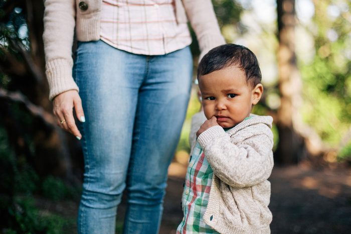 Thoughtful African American Boy holding his mother hand.