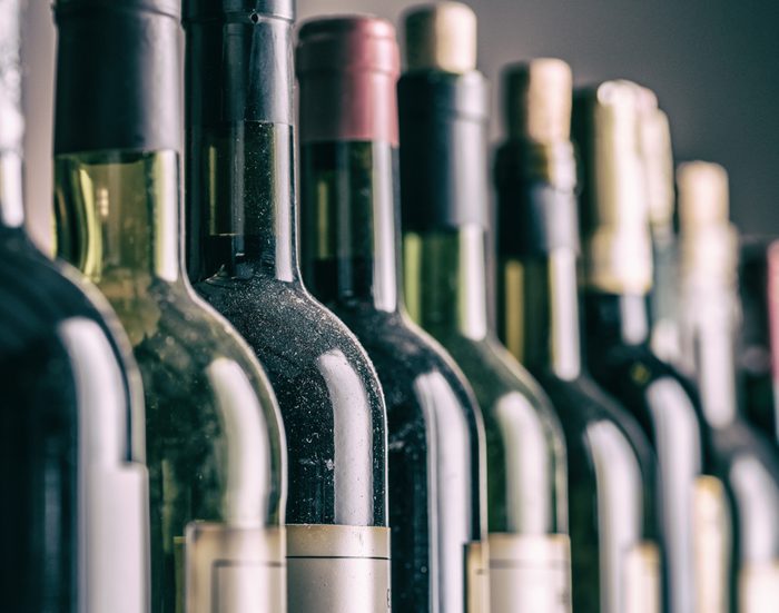 Line of wine bottles. Close-up.
