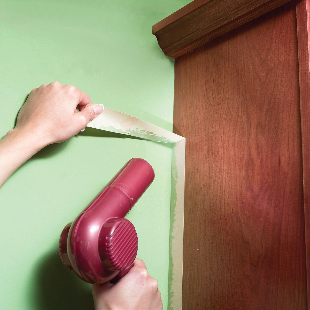 hair dryer being used to remove sticky painters tape