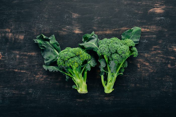 Fresh broccoli on a black wooden background. Top view. Copy space.Fresh broccoli on a black wooden background. Top view. Copy space.