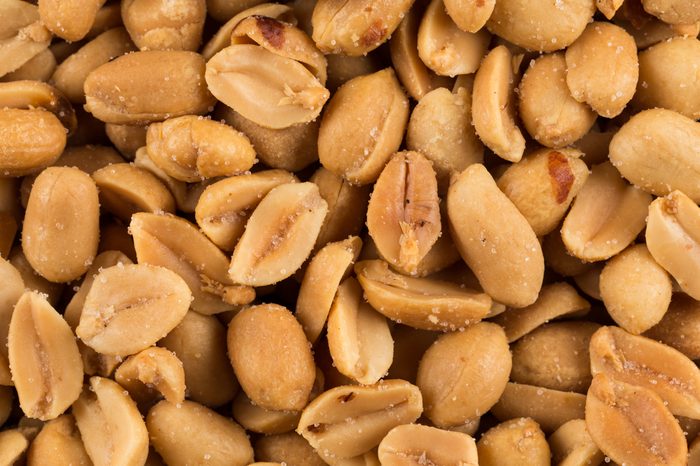 Close-up of a large amount of peeled salted peanuts in a basket