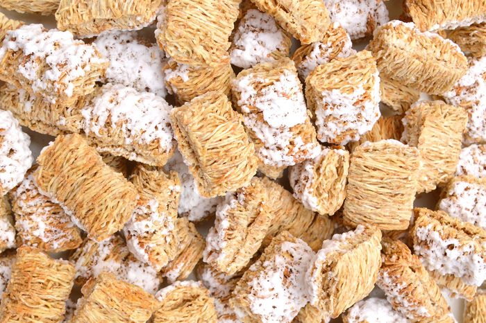 Breakfast setting with frosted wheat cereal on background