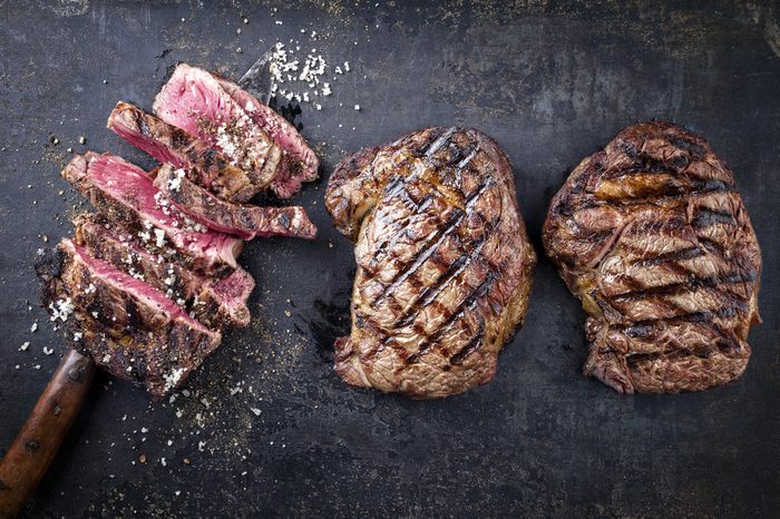 Barbecue Entrecote Steaks on old Metall Sheet