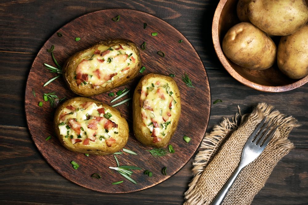 Baked stuffed potatoes with bacon, green onion and cheese, top view