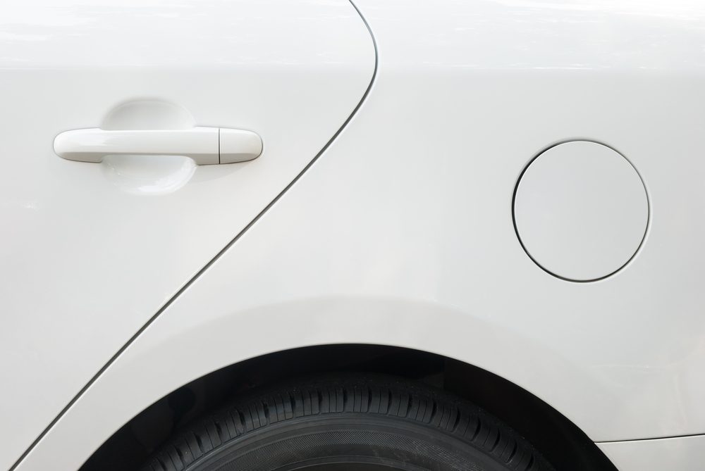 door and tyre and petrol cap cover of a white car